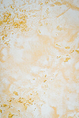 Wall decor Venetian decorative plaster with golden glitter paint. Background, abstraction.
