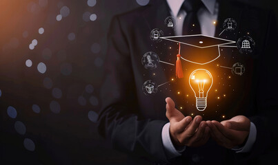 A businessman holds a light bulb with a graduation hat and glowing icons representing education, knowledge sharing, or online learning on a black background, in the style of a training course © Michael