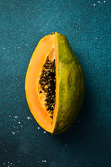 Close up. Top view of fresh ripe papaya on blue concrete background.