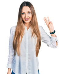Beautiful caucasian woman wearing casual white shirt showing and pointing up with fingers number three while smiling confident and happy.