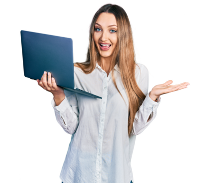 Beautiful caucasian woman working using computer laptop celebrating achievement with happy smile and winner expression with raised hand
