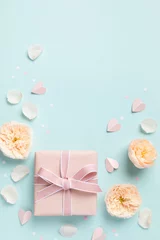 Foto op Plexiglas Lovely greeting card for Birthday, Woman or Mothers Day. Pink hearts, rose flowers and gift box on blue pastel table top view. Flat lay. © juliasudnitskaya