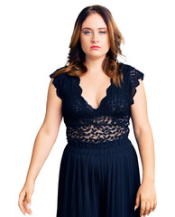 Fototapeta premium Young beautiful caucasian woman wearing elegant dress with serious expression on face. simple and natural looking at the camera.
