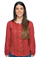 Young hispanic woman wearing casual clothes with a happy and cool smile on face. lucky person.