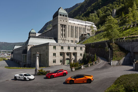 White McLaren 650s, yellow Lamborghini Huracan and Red Ferrari f12 parked in front of the Vemork Museum. Rjukan, Norway - 04.06.2016