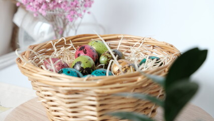 Fototapeta na wymiar Easter quail eggs in a basket. Easter composition. Holiday concept.