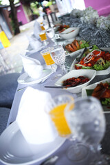 Festive place setup. Empty plates on wedding reception background. Top view. Dining table in luxury wedding. Flat design. Tableware, crockery.