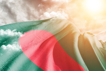 Bangladesh national flag cloth fabric waving on beautiful cloudy Background.