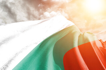 Bulgaria national flag cloth fabric waving on beautiful cloudy Background.