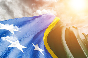 Solomon Islands national flag cloth fabric waving on beautiful cloudy Background.