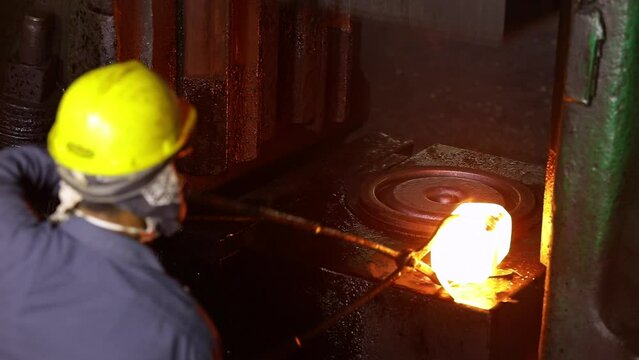 Forging process. hot drop press forges metal piece shaping. drop hammer giving shape to a tool. Open die forging hitting by hammer on a mould cast to form a component part isothermal weld factory	