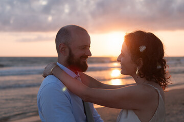 Couple Embracing at Sunset on Beach