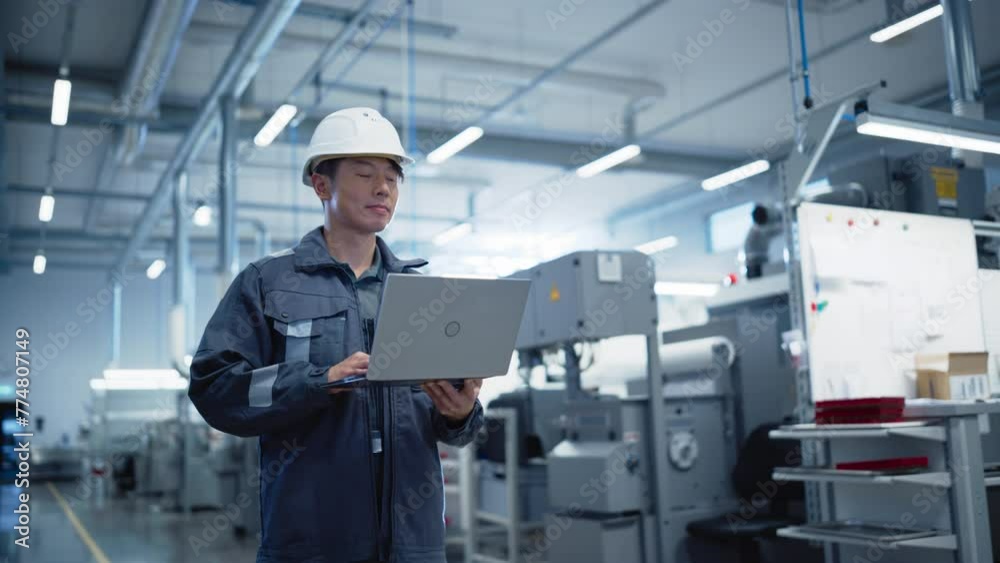 Poster portrait of a professional heavy industry asian engineer in hardhat working on a laptop computer on 
