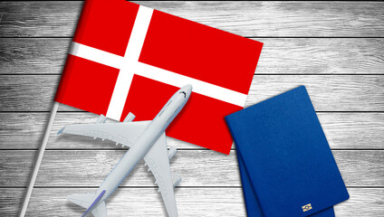 Traveling to Denmark, top view passenger plane on Denmark flag