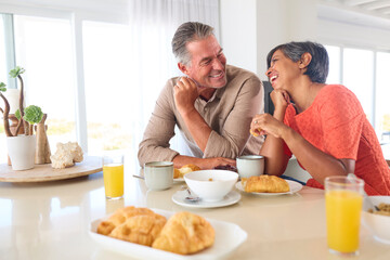Obraz na płótnie Canvas Mature Couple On Vacation Or At Home Eating Breakfast Together