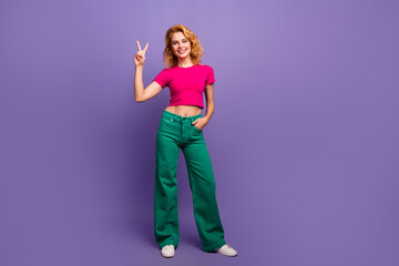 Photo of lovely adorable woman dressed trendy bright clothes hand showing v-sign isolated on purple color background - obrazy, fototapety, plakaty