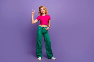 Foto op Plexiglas Photo of lovely adorable woman dressed trendy bright clothes hand showing v-sign isolated on purple color background © deagreez