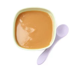 Poster Tasty baby food in bowl and spoon isolated on white, top view © New Africa