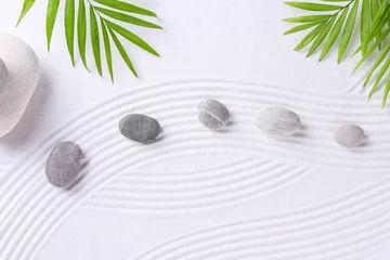 Fotobehang Zen garden stones and green leaves on white sand with pattern, flat lay © New Africa