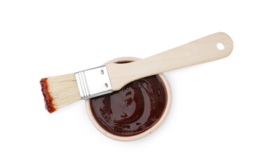 Marinade in bowl and basting brush isolated on white, top view