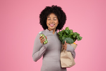 Woman with groceries and drinking green juice