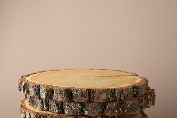 Presentation for product. Wooden stumps on beige background. Space for text