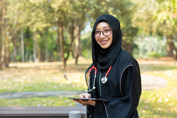 Saudi teen with stethoscope for high education arab women lifestyle in doctor school university campus nature background.