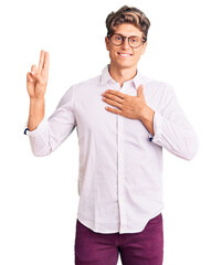 Young handsome man wearing business clothes and glasses smiling swearing with hand on chest and...