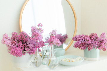 Purple lilac in blue vases with gold mirror beautiful spring inspiration floral space