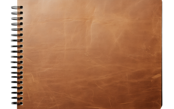 A weathered brown leather notebook lies open on a wooden desk, waiting for the next chapter to be written