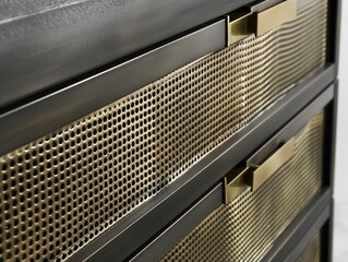 Modern cabinet design with intricate grid pattern on the front, dark wood and copper accents, creating a sleek and stylish atmosphere. metal mesh elements, functional storage space in drawers.