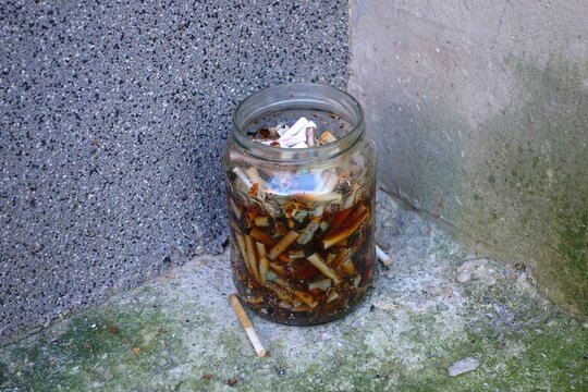 People take a break from work - makeshift ashtray for a jar for cigarettes