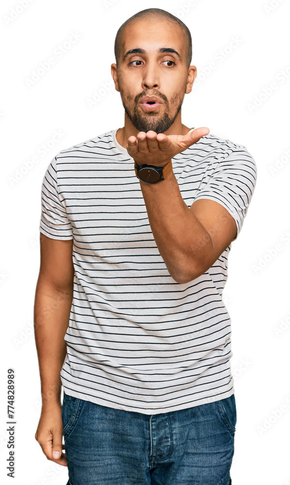 Poster Hispanic adult man wearing casual clothes looking at the camera blowing a kiss with hand on air being lovely and sexy. love expression.