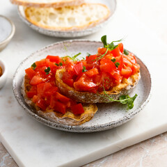 Traditional tomato bruschetta with greens