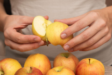 Hands Picking a Fresh Apple. Female hands holding fresh ripe apple.