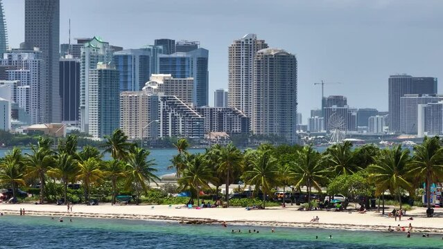 Hobie Island Beach on Virginia Key and downtown office district of Miami Brickell in Florida, USA. Waterfront commercial and residential skyscraper buildings