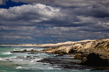 sea dunes and rocks with heavy clouds at the coastline of indian ocean at De Hoop Nature Reserve south africa