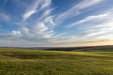 Looking out over fields with evening light, from Ditchling Beacon in the Sussex countryside