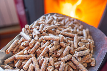 close-up view of wood waste pellets near a stove