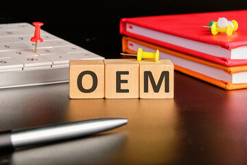 Acronym concept. OEM Original Equipment Manufacturer on wooden cubes with a calculator and...