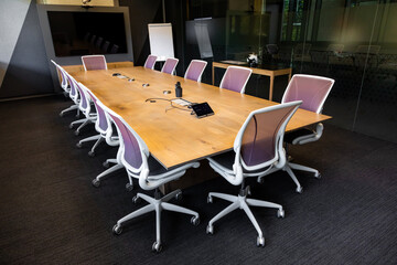 Empty boardroom table and chairs