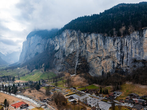 Beautiful autumn time at village of Lauterbrunnen in Swiss alps, gateway to famous Jungfrau. Set in a valley featuring rocky cliffs and the roaring, 300m high Staubbach Falls