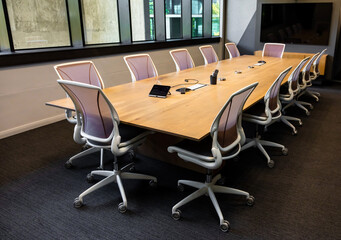 Empty boardroom table and chairs