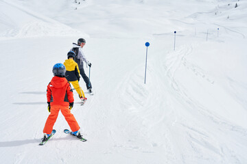 Picture of mother teach skiing her kids in Madonna di Campiglio - obrazy, fototapety, plakaty