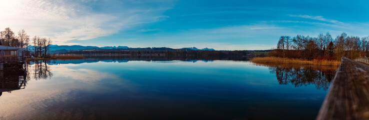 High resolution stitched alpine winter panorama with reflections at Lake Waginger See, Traunstein, Bavaria, Germany