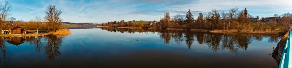High resolution stitched alpine winter panorama with reflections at Lake Waginger See, Traunstein, Bavaria, Germany