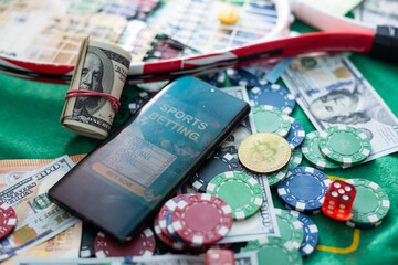 Mobile phone casino online. Mobile phone and game cards with chips and dice on a green gaming...