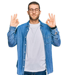Young caucasian man wearing casual clothes relaxed and smiling with eyes closed doing meditation gesture with fingers. yoga concept.