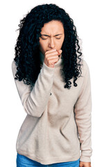 Young hispanic woman with curly hair wearing turtleneck sweater feeling unwell and coughing as...