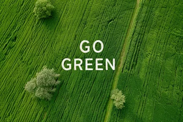 Fototapete Rund Aerial view of a green field landscape with Go Green text © grey